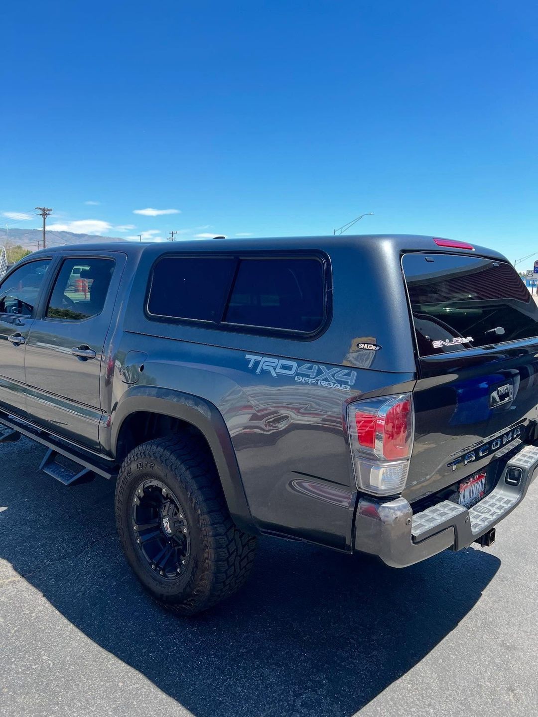 Gray SnugTop camper shell on a Toyota Tacoma TRD 4x4